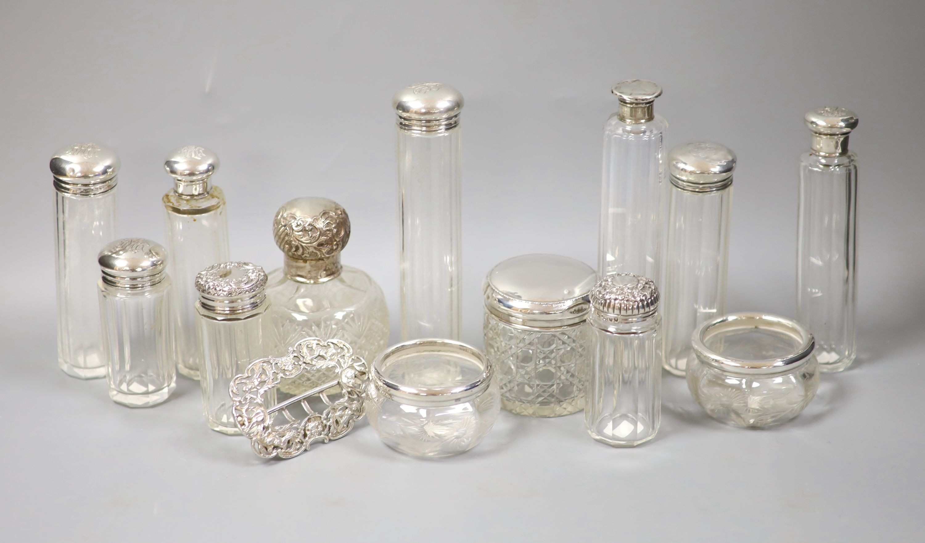 Assorted silver mounted toilet jars and a late Victorian silver belt buckle, London, 1897.